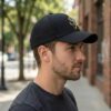 xqjuyyeT_6CUM8QM5GZ_2026-03-12_2.jpg Flying Eagle Graphic Black Baseball Cap for Men & Women | Adjustable Unisex Streetwear Hat with Geometric Eagle Design, Casual Fashion Sports Cap for Daily Wear