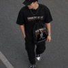 Black Oversized Graphic T-Shirt with Bold Typography Print and Back Artwork Design Paired with Matching Adjustable Cap and Printed Drawstring Bag Combo Set Streetwear Casual Outfit