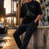 ChatGPT Image Jul 21, 2026, 12_50_51 PM Men Black Oversized Graphic T-Shirt with Crown Front Detail and Bold Tech-Inspired Back Print Streetwear Style