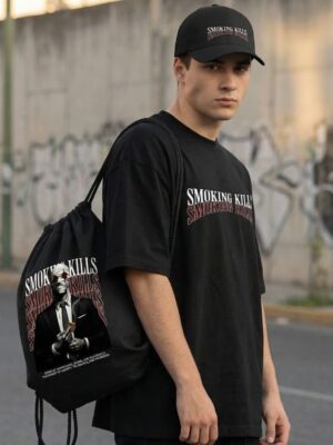 Black Oversized Graphic T-Shirt with Bold Typography Print and Back Artwork Design Paired with Matching Adjustable Cap and Printed Drawstring Bag Combo Set Streetwear Casual Outfit